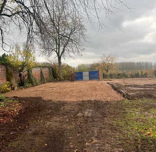 Grondwerken bij de toegangspoort van een perceel